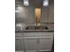 Granite countertop featuring a stainless steel sink and modern faucet with pendant lighting above at 7321 N 123Rd Dr, Glendale, AZ 85307