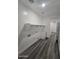 Bright laundry room featuring modern sink, storage and gray wood-look flooring at 7321 N 123Rd Dr, Glendale, AZ 85307