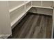 Pantry with white shelving and gray wood-style floors for storing food and kitchen supplies at 7321 N 123Rd Dr, Glendale, AZ 85307