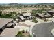 Aerial view of a two-story home, three car garage, circular drive, desert landscaping and mountain views at 7398 W Paso Trl, Peoria, AZ 85383