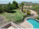 Spacious backyard featuring a well-maintained lawn, mature trees, landscaping, and a refreshing pool for outdoor enjoyment at 7398 W Paso Trl, Peoria, AZ 85383