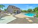 Wide shot of the property's backyard with the pool, outdoor kitchen, and patio at 7398 W Paso Trl, Peoria, AZ 85383