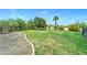 Large grassy backyard area with desert landscaping, a rock border, and gravel area at 7398 W Paso Trl, Peoria, AZ 85383