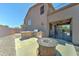 Backyard featuring outdoor kitchen, gas grill, fire pit and covered patio with ceiling fan at 7398 W Paso Trl, Peoria, AZ 85383