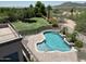 View of a backyard pool with mountain views, desert landscaping, and privacy fence at 7398 W Paso Trl, Peoria, AZ 85383