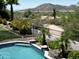 Close up view of a backyard pool with mountain views and desert landscaping at 7398 W Paso Trl, Peoria, AZ 85383