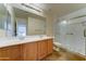 Bright bathroom features a double vanity and walk-in shower with glass enclosure at 7398 W Paso Trl, Peoria, AZ 85383