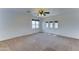 Large, carpeted bedroom with bright natural light and a ceiling fan at 7398 W Paso Trl, Peoria, AZ 85383