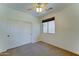 Neutral bedroom features a window, carpet, and double door closet at 7398 W Paso Trl, Peoria, AZ 85383