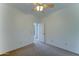 Neutral bedroom features a ceiling fan, carpet, and white walls at 7398 W Paso Trl, Peoria, AZ 85383