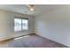 Bedroom with cozy carpet, a ceiling fan, and a large window offering lots of natural light at 7398 W Paso Trl, Peoria, AZ 85383