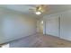 Bedroom features neutral carpet, crown molding, a ceiling fan, and a closet with sliding doors at 7398 W Paso Trl, Peoria, AZ 85383