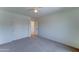 Bedroom featuring neutral carpet, an open doorway, and a spacious closet with sliding doors at 7398 W Paso Trl, Peoria, AZ 85383