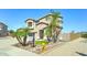 Traditional two-story home featuring a three-car garage, desert landscaping, and a charming front entrance at 7398 W Paso Trl, Peoria, AZ 85383