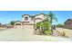 Traditional two-story home featuring a three-car garage, desert landscaping, and a charming front entrance at 7398 W Paso Trl, Peoria, AZ 85383