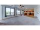Spacious living room with large windows overlooking the backyard and adjoined to the kitchen at 7398 W Paso Trl, Peoria, AZ 85383