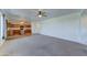 Inviting living room with plush carpet, tile entry, neutral walls and a view of the kitchen with island through an archway at 7398 W Paso Trl, Peoria, AZ 85383