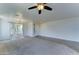 Inviting living room with plush carpet, tile entry, neutral walls, and plenty of windows, creating a warm and bright space at 7398 W Paso Trl, Peoria, AZ 85383