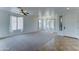 Inviting living room with plush carpet, tile entry, neutral walls, and plenty of windows, creating a warm and bright space at 7398 W Paso Trl, Peoria, AZ 85383