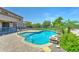 Inviting backyard pool featuring a safety fence, rock features, and desert landscaping at 7398 W Paso Trl, Peoria, AZ 85383