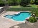 Inviting backyard pool with lush landscaping, a safety fence, and a serene oasis for relaxation and entertainment at 7398 W Paso Trl, Peoria, AZ 85383