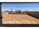 Spacious backyard featuring fresh dirt, surrounded by a brick wall, and desert landscaping beyond at 804 W Lark Dr, Queen Creek, AZ 85140