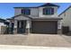 Charming two-story home featuring a brick-paved driveway and a welcoming front porch at 804 W Lark Dr, Queen Creek, AZ 85140