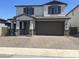 Charming two-story home featuring a brick-paved driveway and a welcoming front porch at 804 W Lark Dr, Queen Creek, AZ 85140
