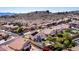 Aerial view of desert homes with red tile roofs, landscaping, and scenic mountain backdrop at 818 E Hiddenview Dr, Phoenix, AZ 85048