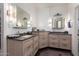 Elegant bathroom with dual vanities, granite countertops, stylish mirrors, and designer lighting at 818 E Hiddenview Dr, Phoenix, AZ 85048
