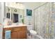 This bathroom features a single sink vanity, a framed mirror, and a shower/tub combo with a fun shower curtain at 818 E Hiddenview Dr, Phoenix, AZ 85048