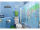 Unique blue bathroom with vibrant décor, including a world map shower curtain at 818 E Hiddenview Dr, Phoenix, AZ 85048