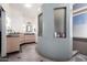Bright bathroom featuring a vanity with double sinks, a mirror, and a walk in shower with built in shelves at 818 E Hiddenview Dr, Phoenix, AZ 85048