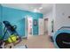 Bright bedroom with blue accent wall, ceiling fan, and multiple entry points at 818 E Hiddenview Dr, Phoenix, AZ 85048