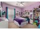 Bright bedroom with a colorful gradient comforter, ceiling fan, and filled bookshelf, creating a vibrant and inviting space at 818 E Hiddenview Dr, Phoenix, AZ 85048