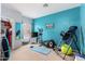Bright bedroom with turquoise accent wall, inversion table, exercise equipment, and ample space at 818 E Hiddenview Dr, Phoenix, AZ 85048