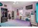 Bright bedroom with decor, walk-in closet, ensuite bathroom, vanity, dresser, and ceiling fan at 818 E Hiddenview Dr, Phoenix, AZ 85048