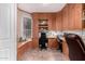 This home office features custom cabinets, built in shelving, and a large window with great natural light at 818 E Hiddenview Dr, Phoenix, AZ 85048