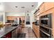 Kitchen featuring stainless steel appliances, double ovens, and an island with a sink at 818 E Hiddenview Dr, Phoenix, AZ 85048