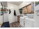 Functional laundry room with a washer, dryer, sink, and convenient storage at 818 E Hiddenview Dr, Phoenix, AZ 85048