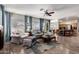 Inviting living room showcasing plush seating, large windows, and an open layout to the kitchen at 818 E Hiddenview Dr, Phoenix, AZ 85048