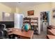 Home office featuring a desk, shelving, and a connected storage closet at 818 E Hiddenview Dr, Phoenix, AZ 85048