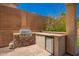 Entertain in style with this outdoor kitchen featuring a built-in grill and beverage refrigerator at 818 E Hiddenview Dr, Phoenix, AZ 85048