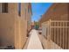 Narrow side yard with pavers leading to a metal gate between the home and a tall brick wall at 818 E Hiddenview Dr, Phoenix, AZ 85048