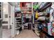 Large walk-in closet with extensive shelving and storage solutions, adjacent to a bathroom at 818 E Hiddenview Dr, Phoenix, AZ 85048