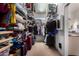 Spacious walk-in closet with ample storage, including shelving, hanging rods, and luggage space at 818 E Hiddenview Dr, Phoenix, AZ 85048