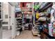 Large walk-in closet with extensive shelving and storage solutions, adjacent to a bathroom at 818 E Hiddenview Dr, Phoenix, AZ 85048