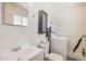 Bright bathroom featuring a modern vanity, toilet, and convenient, in-unit washer and dryer setup at 8210 E Garfield St # K23, Scottsdale, AZ 85257