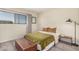 Cozy bedroom featuring a green bedspread, wood floors, and large window at 8210 E Garfield St # K23, Scottsdale, AZ 85257