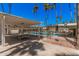 Shaded common area with picnic tables by the community pool, for socializing and outdoor dining at 8210 E Garfield St # K23, Scottsdale, AZ 85257